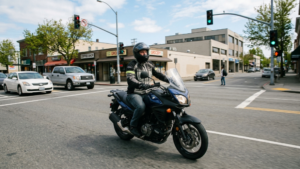Motorcyclist observing traffic hazards near an intersection